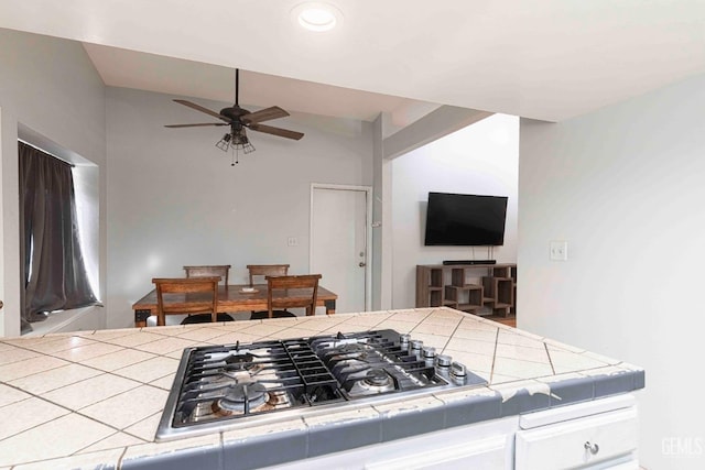 kitchen featuring ceiling fan, tile countertops, and stainless steel gas cooktop