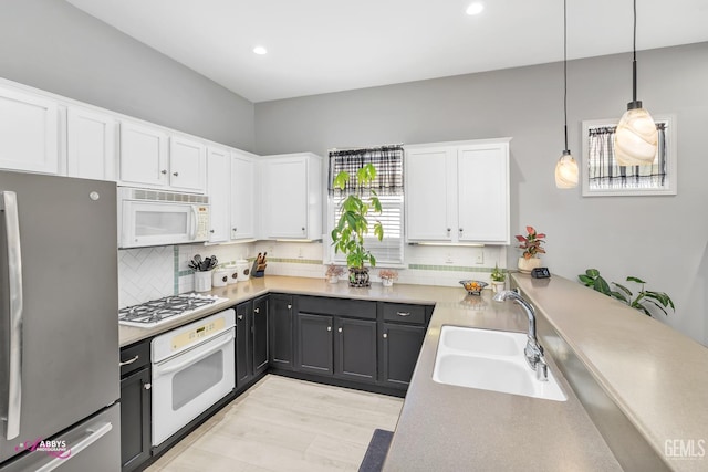 13918 Calico Village Dr, Bakersfield, CA 93306 - kitchen featuring white appliances, a sink, white cabinetry, decorative backsplash, and recessed lighting