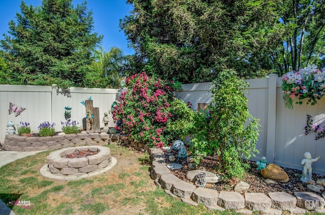 13918 Calico Village Dr, Bakersfield, CA 93306 - fenced backyard with an outdoor fire pit