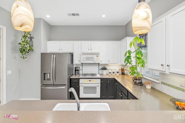 13918 Calico Village Dr, Bakersfield, CA 93306 - kitchen featuring white appliances, a sink, decorative backsplash, white cabinets, and recessed lighting