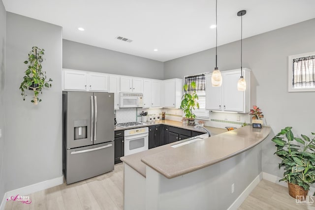 13918 Calico Village Dr, Bakersfield, CA 93306 - kitchen with white appliances, a sink, a peninsula, baseboards, and white cabinets
