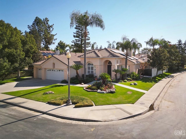 mediterranean / spanish-style home with a front lawn and a garage