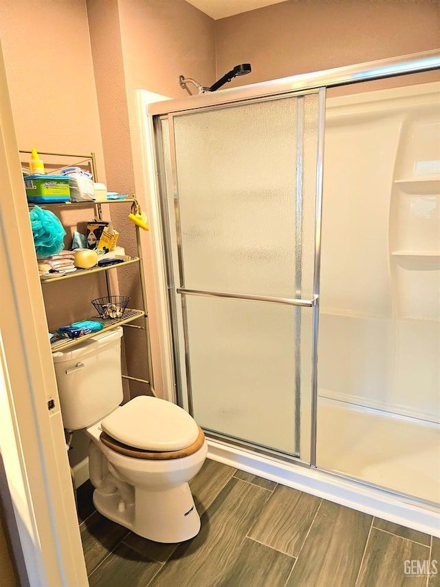 10026 Maya Linda Rd Unit 6101, San Diego, CA 92126 - full bath featuring toilet, a stall shower, and wood tiled floors