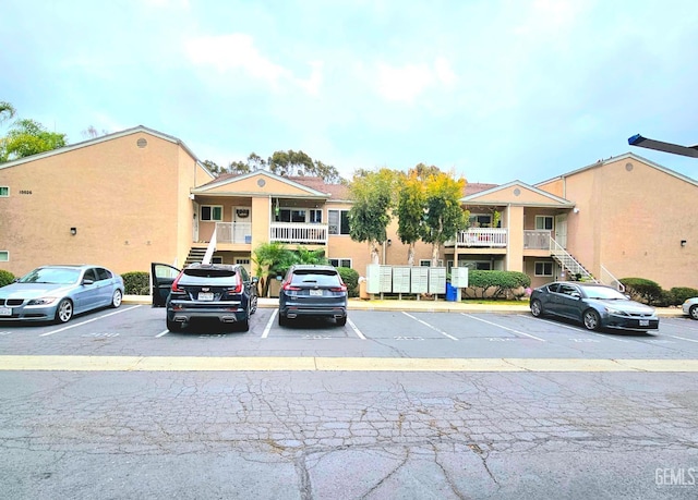 10026 Maya Linda Rd Unit 6101, San Diego, CA 92126 - view of building exterior with uncovered parking and stairs