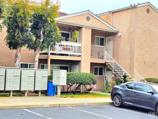10026 Maya Linda Rd Unit 6101, San Diego, CA 92126 - view of building exterior with uncovered parking and stairs
