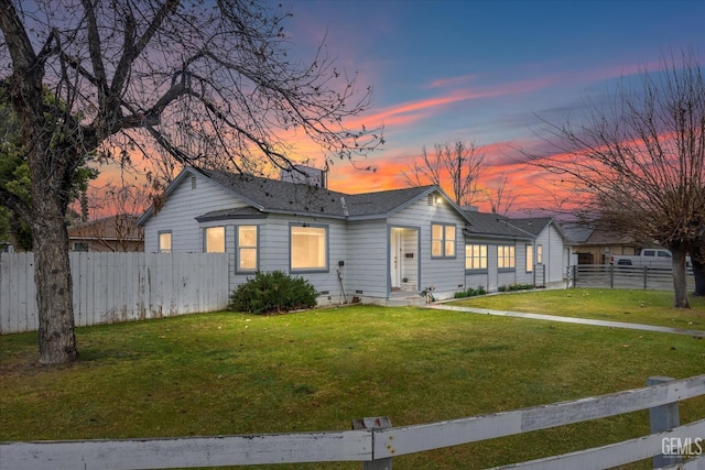 ranch-style home with a yard