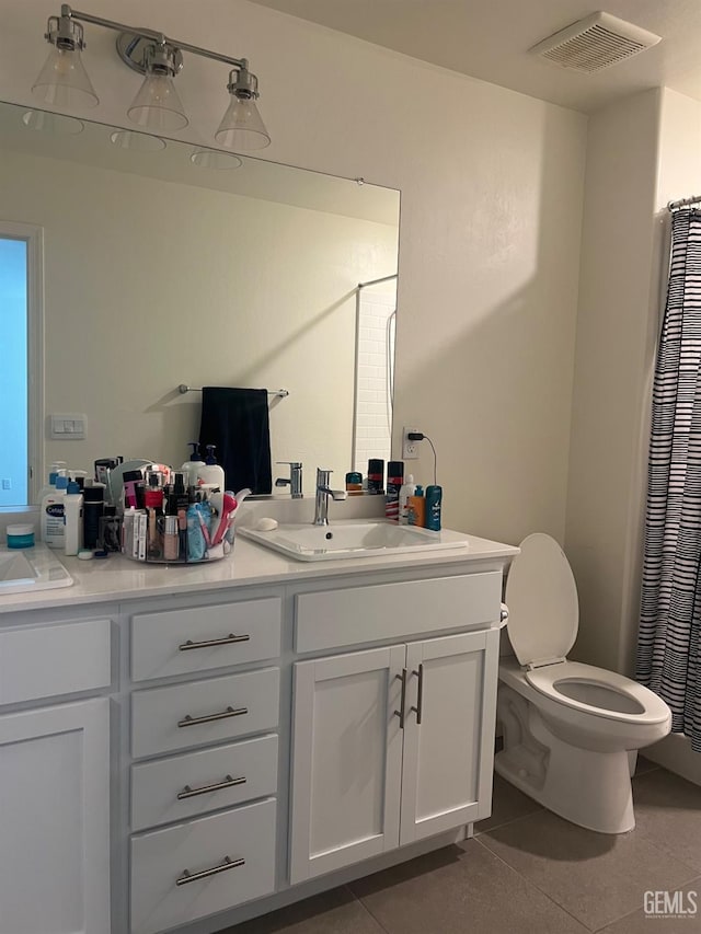 full bath with double vanity, visible vents, toilet, tile patterned floors, and a sink