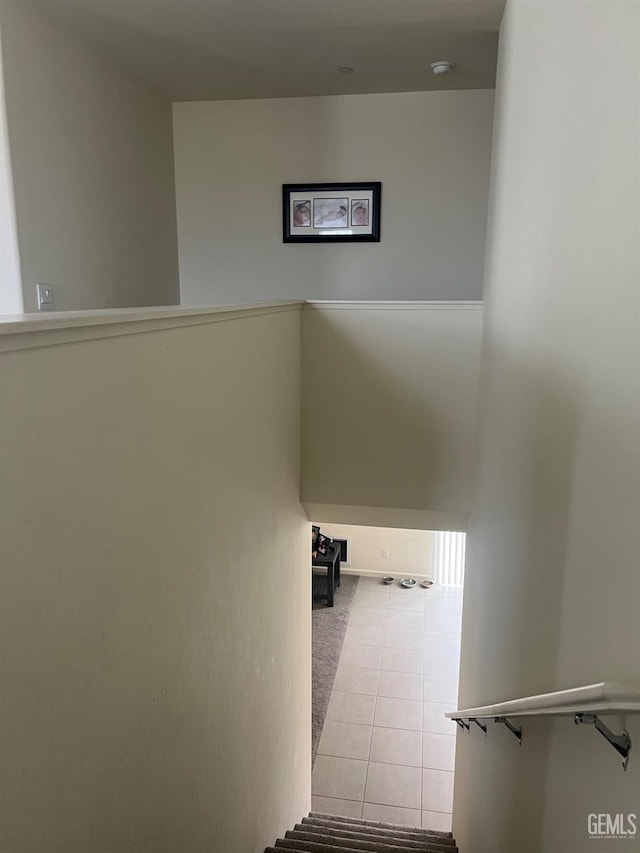 stairs featuring tile patterned flooring