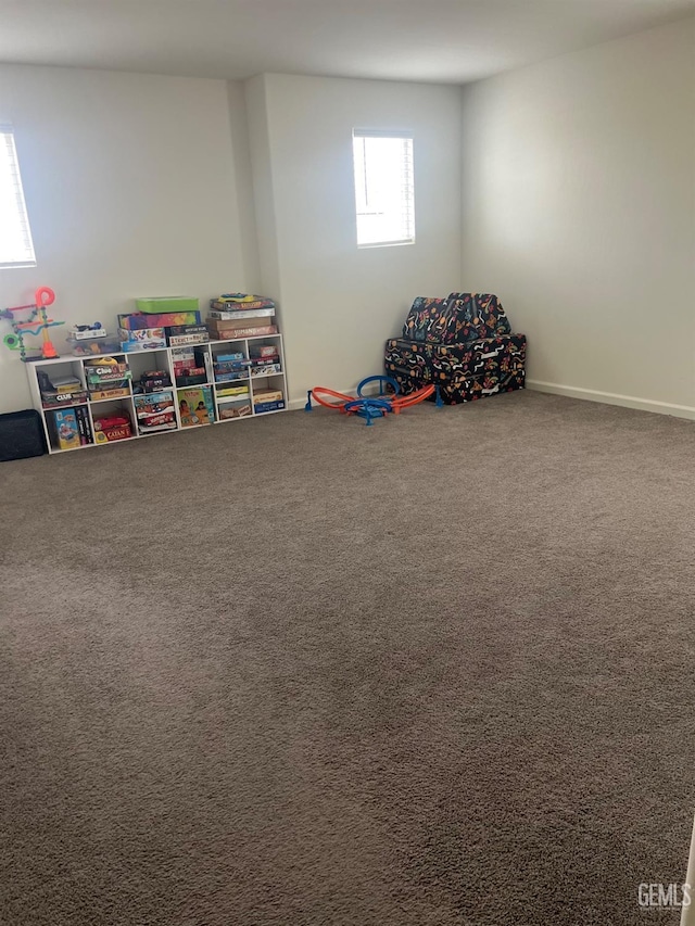 game room with carpet and baseboards