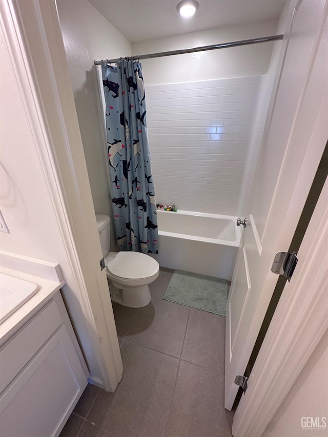 full bath with shower / bath combination with curtain, tile patterned flooring, vanity, and toilet