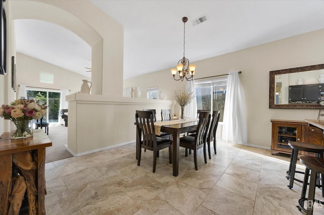 dining space with lofted ceiling and a notable chandelier