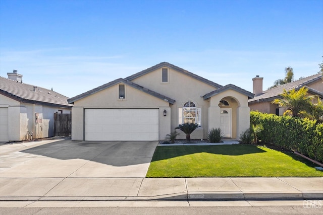 ranch-style house featuring a garage and a front yard