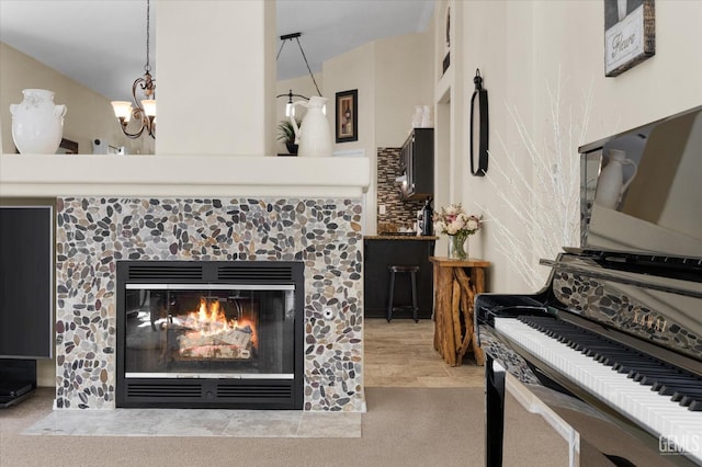 interior space with an inviting chandelier and a tile fireplace