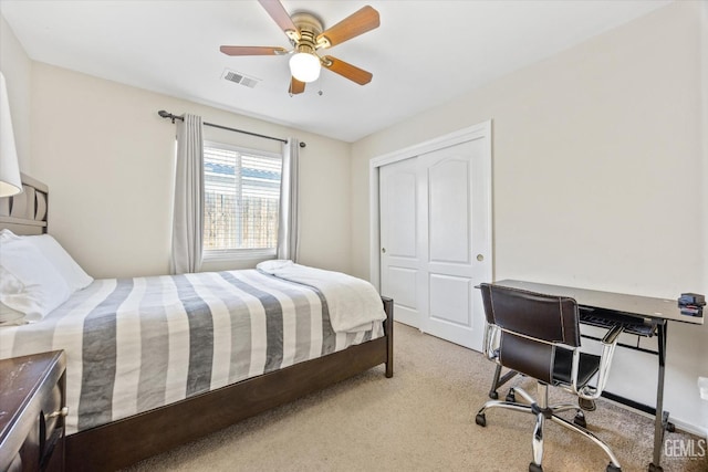 carpeted bedroom featuring ceiling fan and a closet