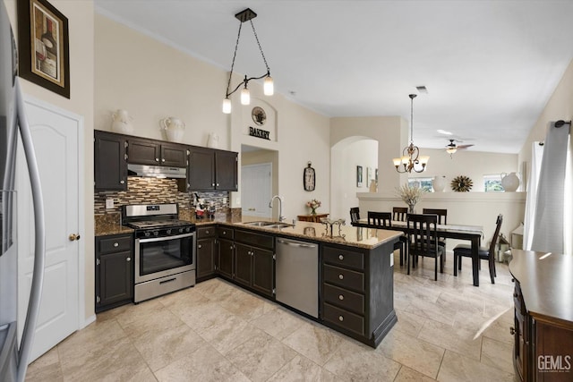 kitchen with pendant lighting, sink, appliances with stainless steel finishes, backsplash, and kitchen peninsula