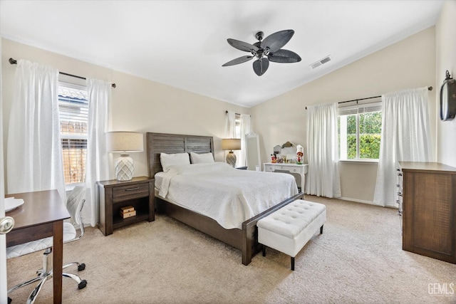 bedroom with lofted ceiling, light colored carpet, and ceiling fan