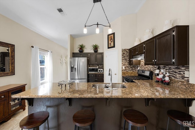 kitchen with appliances with stainless steel finishes, sink, and dark brown cabinets