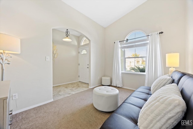 carpeted living room featuring lofted ceiling