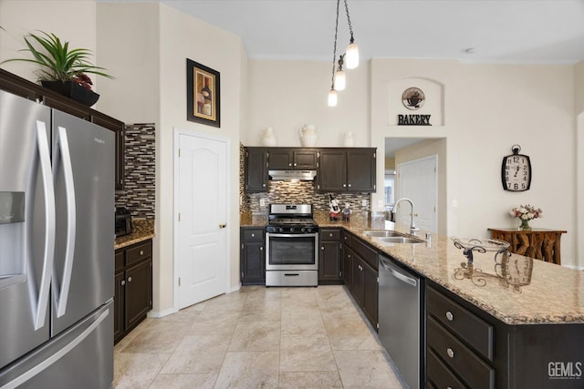 kitchen featuring sink, decorative light fixtures, decorative backsplash, and appliances with stainless steel finishes