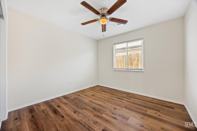 unfurnished room with dark wood-type flooring and ceiling fan