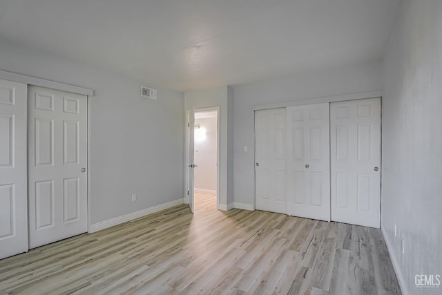 unfurnished bedroom featuring light wood-style flooring, visible vents, and baseboards