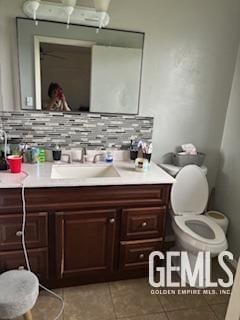 2529 Pinon Springs Circle W, Bakersfield, CA 93309 - bathroom with vanity, tile patterned floors, backsplash, and toilet