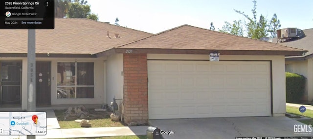 2529 Pinon Springs Circle W, Bakersfield, CA 93309 - single story home with roof with shingles, brick siding, central air condition unit, and an attached garage