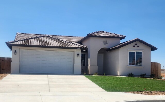 4620 Dry Port Way, Bakersfield, CA 93306 - mediterranean / spanish-style home featuring stucco siding, an attached garage, concrete driveway, and a tile roof