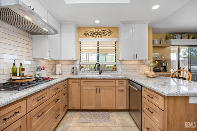 kitchen featuring white cabinets, sink, tasteful backsplash, and range hood