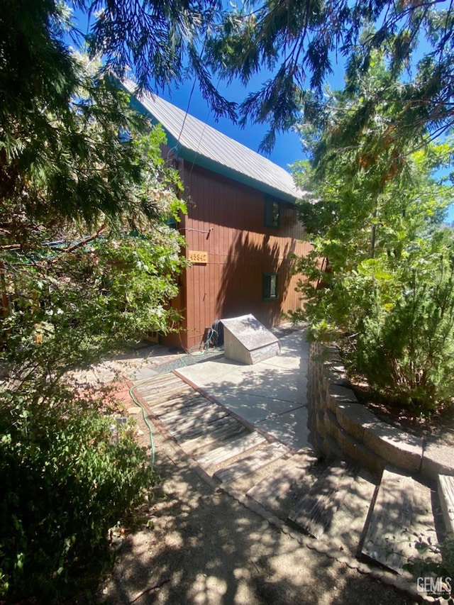 view of side of home with a patio area