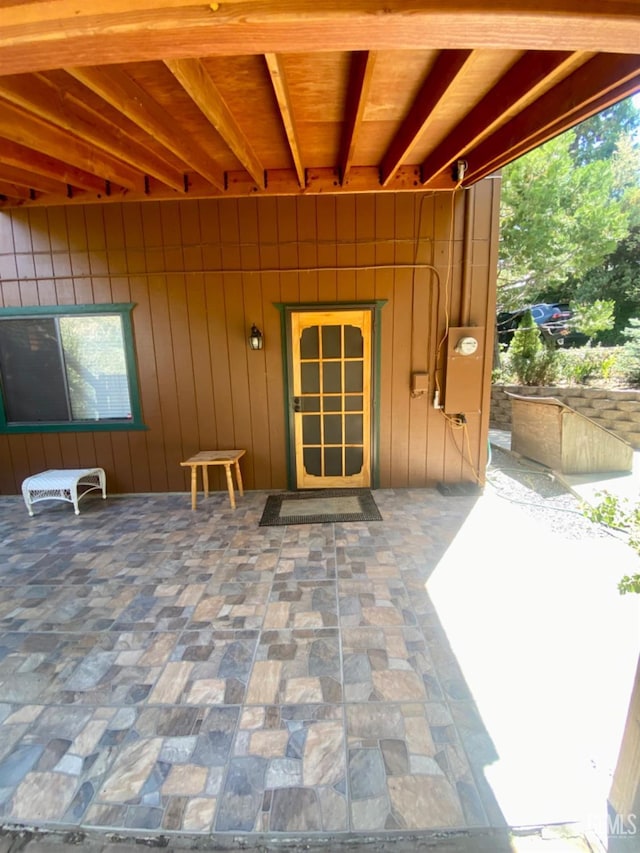 property entrance featuring a patio area