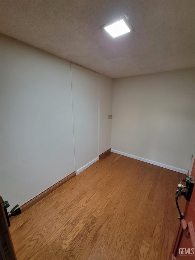6918 Crestwood St, Bakersfield, CA 93308 - spare room featuring wood finished floors and a textured ceiling