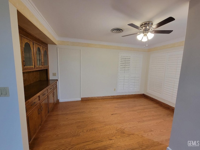 6918 Crestwood St, Bakersfield, CA 93308 - unfurnished room with ceiling fan, crown molding, and light wood finished floors