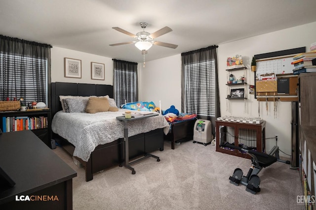 bedroom with light carpet, stainless steel refrigerator, and ceiling fan