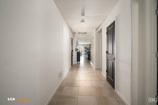 hallway featuring light tile patterned flooring