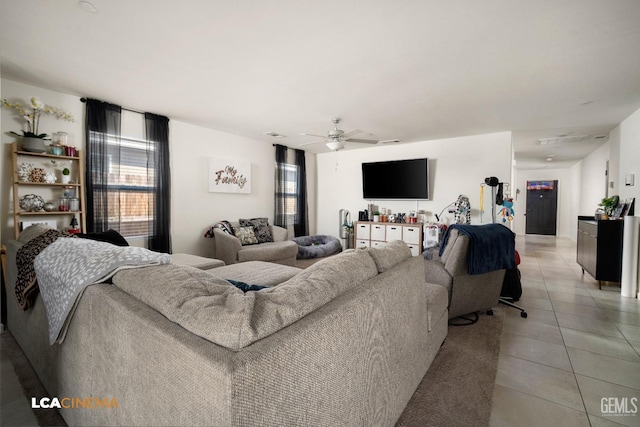 living room featuring ceiling fan, light tile patterned floors, and a healthy amount of sunlight