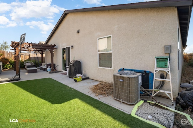 rear view of house with a pergola, central air condition unit, a patio area, and a yard