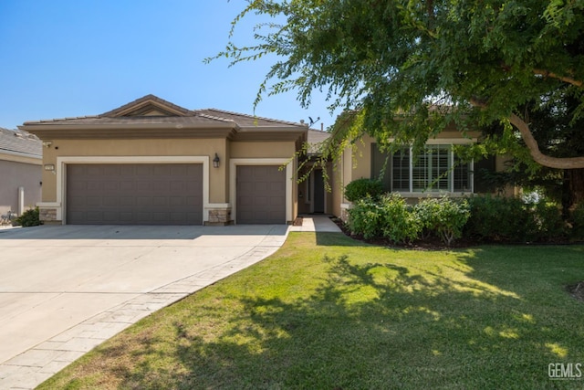 5703 Park Pl, Bakersfield, CA 93306 - view of front of property featuring a garage, concrete driveway, a front yard, and stucco siding