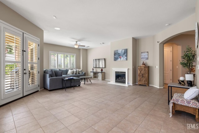 5703 Park Pl, Bakersfield, CA 93306 - living area featuring a ceiling fan, arched walkways, light tile patterned floors, and a glass covered fireplace