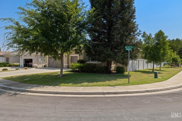 5703 Park Pl, Bakersfield, CA 93306 - obstructed view of property with driveway, an attached garage, and stucco siding
