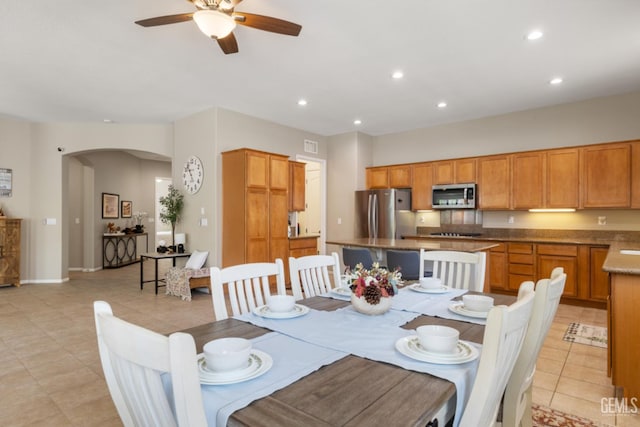 5703 Park Pl, Bakersfield, CA 93306 - dining space with arched walkways, ceiling fan, recessed lighting, and light tile patterned floors