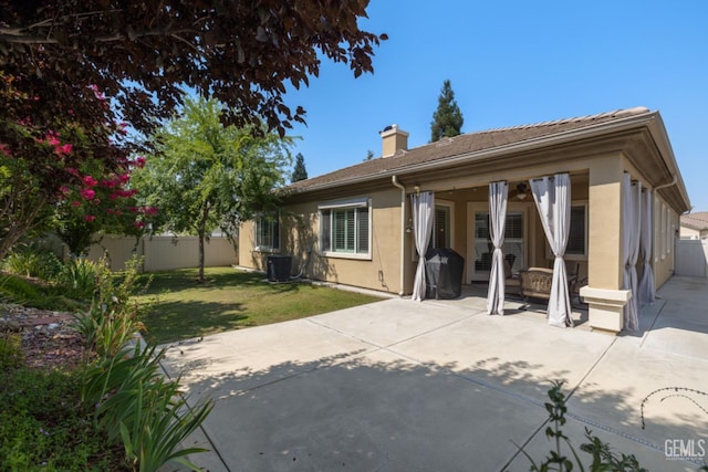 5703 Park Pl, Bakersfield, CA 93306 - back of property with stucco siding, a fenced backyard, a patio area, and a chimney