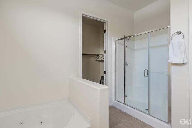 5703 Park Pl, Bakersfield, CA 93306 - full bath featuring a shower stall, a tub with jets, tile patterned flooring, and a walk in closet
