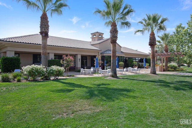 5703 Park Pl, Bakersfield, CA 93306 - back of property with a patio, a yard, stucco siding, and a tile roof