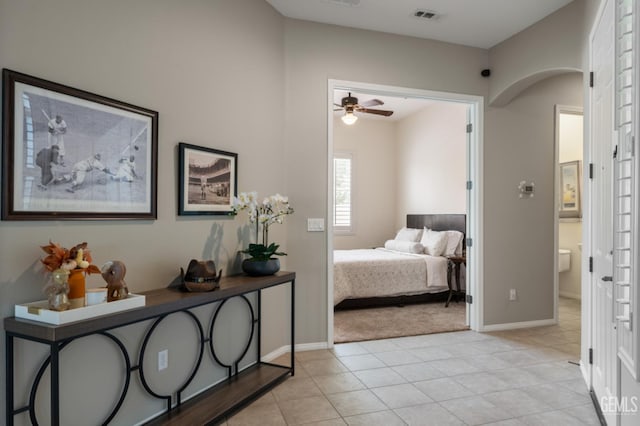 5703 Park Pl, Bakersfield, CA 93306 - bedroom featuring arched walkways, light tile patterned floors, and light carpet