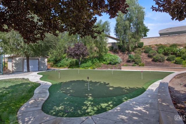 5703 Park Pl, Bakersfield, CA 93306 - view of swimming pool with an area to practice putting and an outdoor structure