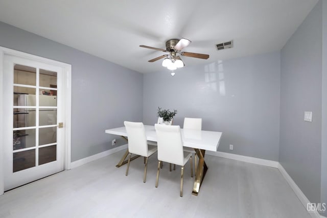 dining room with ceiling fan and light hardwood / wood-style floors