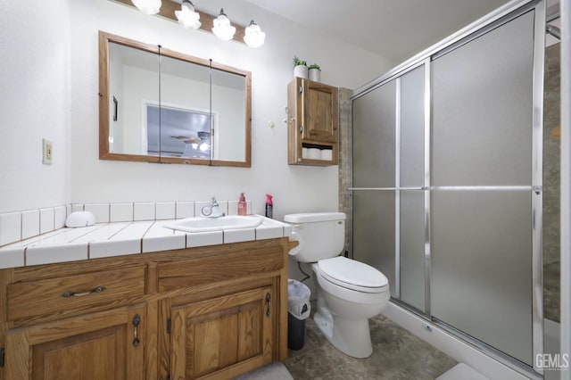 bathroom with vanity, toilet, and walk in shower