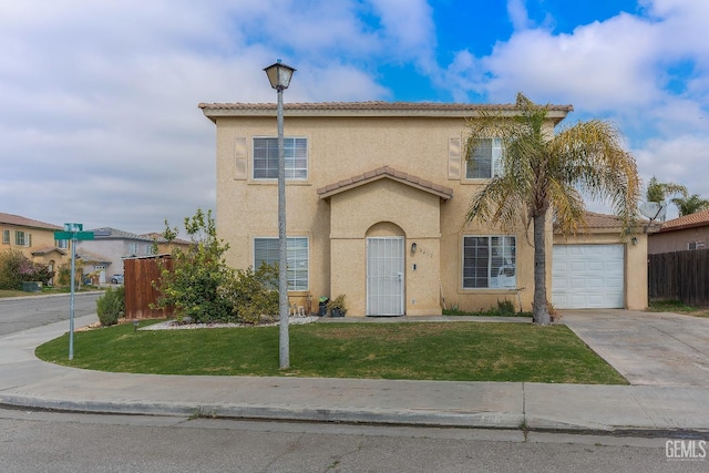 view of front of property with a front yard, concrete driveway, fence, and stucco siding