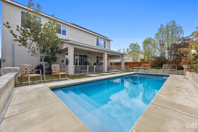 view of pool with a patio, fence, a fenced in pool, and ceiling fan